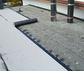 palm beach roofing 3 rolls of underlayment on flat roof. we work clean and organized.